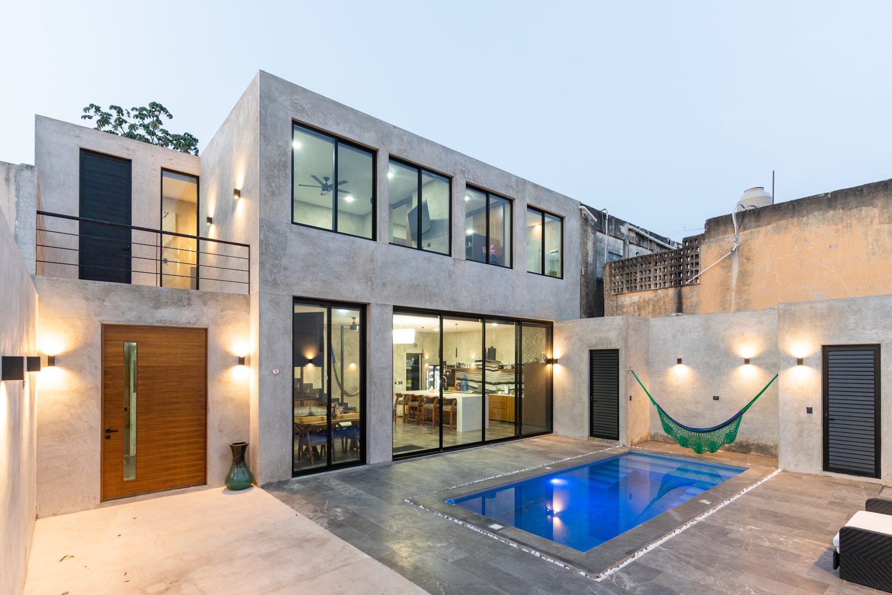 A restored home with courtyard pool in Mérida, Mexico at dusk