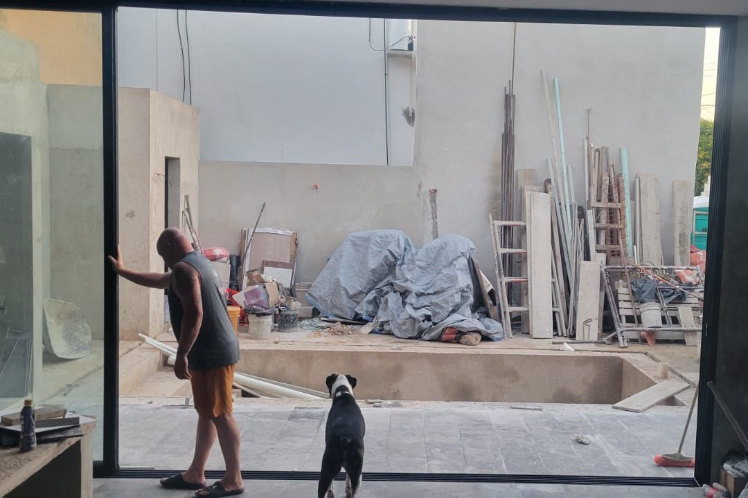 Ken Bell checking a pool under construction at a renovation project