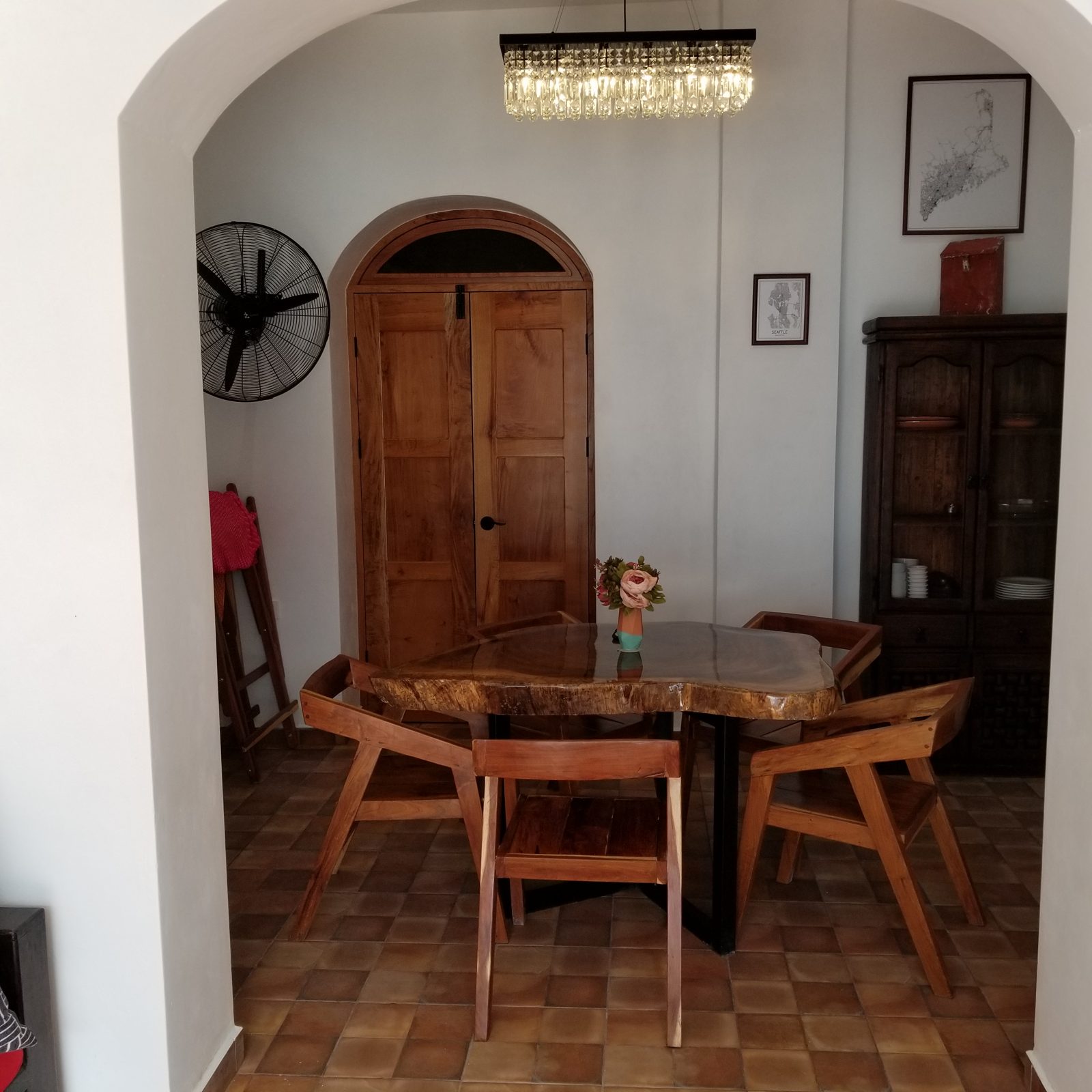 Dining room with live-edge table under an arch