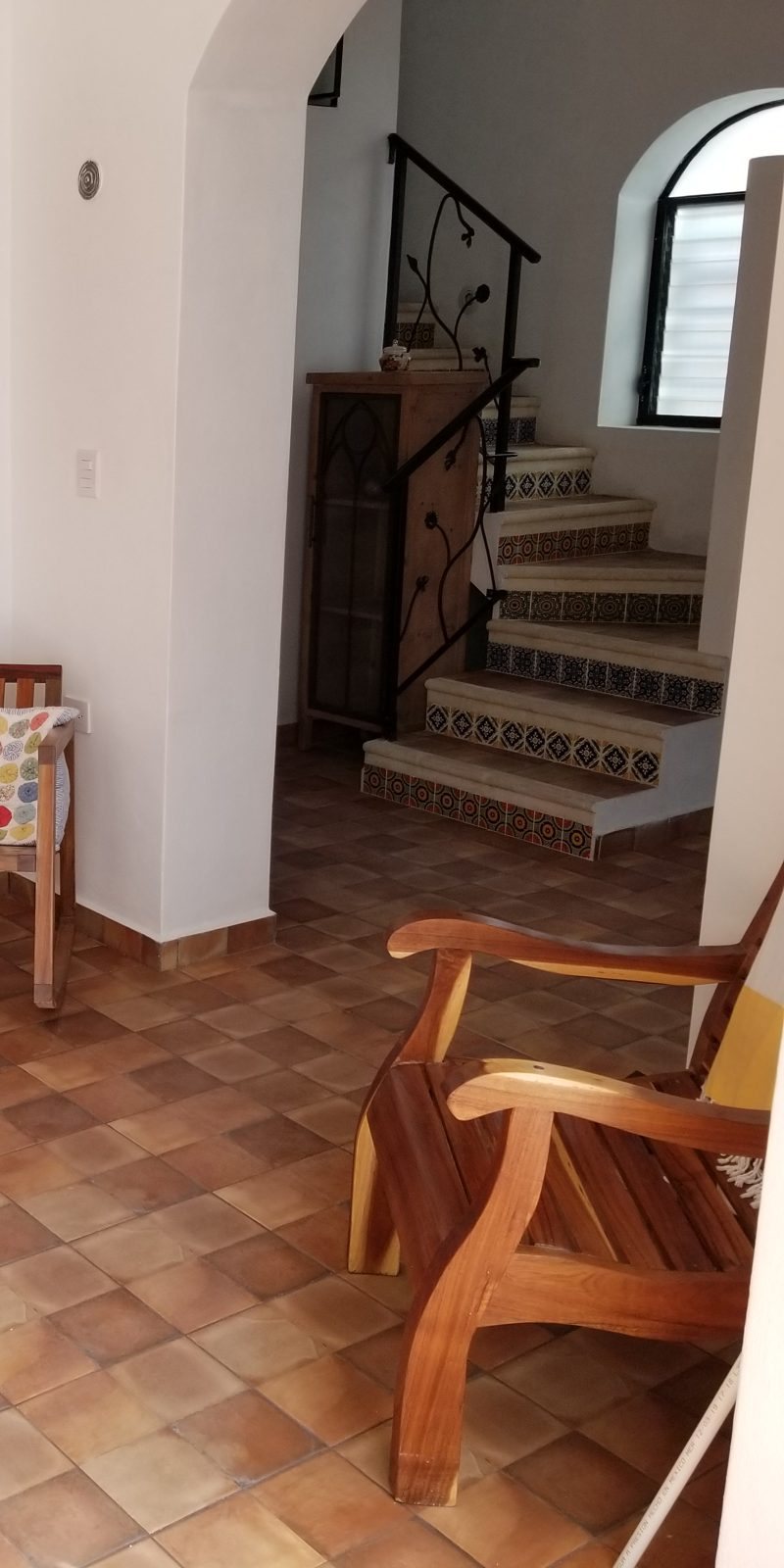 Warm tiled interior with a Talavera staircase