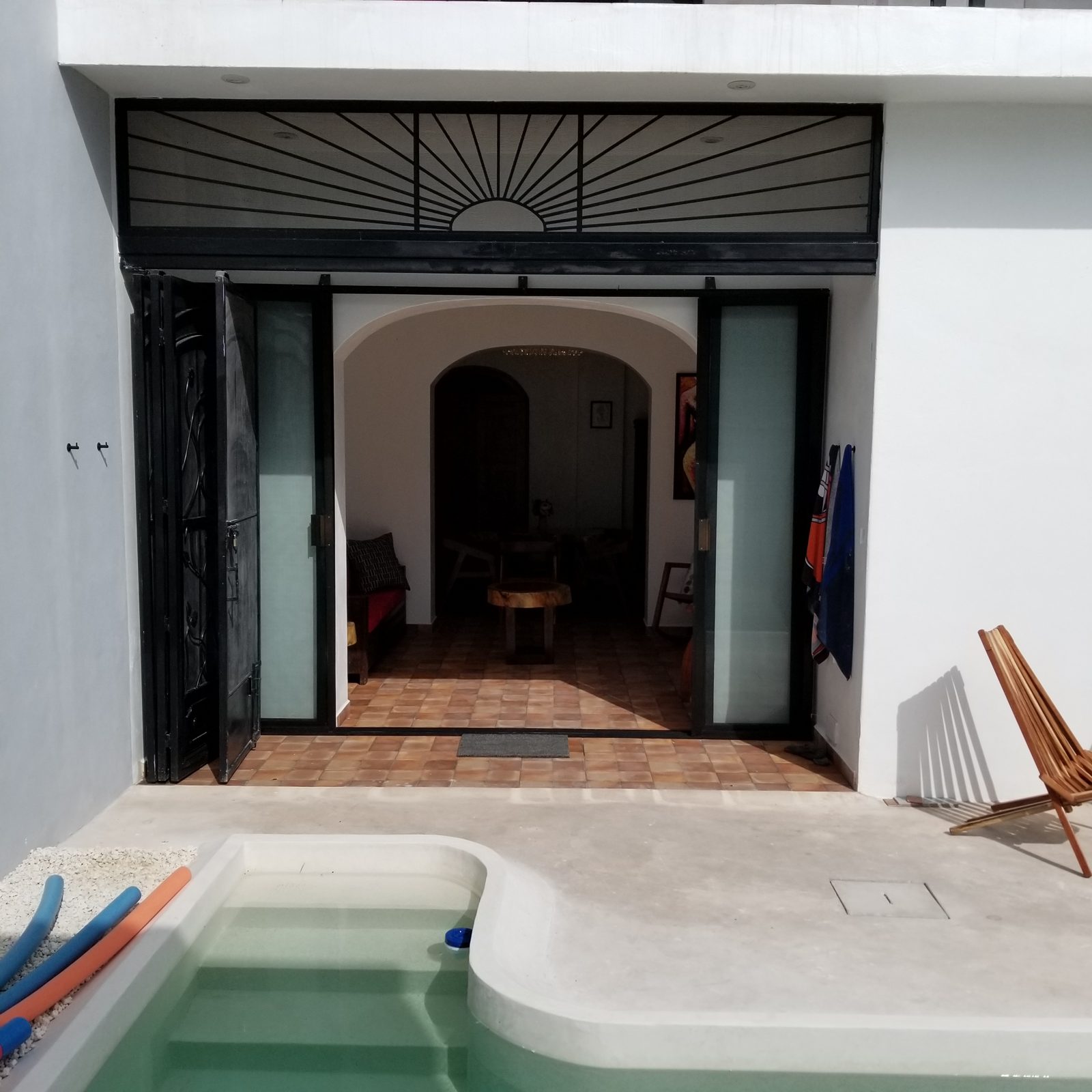 Plunge pool opening to a tiled living room